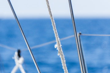 Sailboat Shrouds and Ropes with Blurred Blue Sea and Sky Background