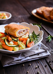 Chicken breasts chops stuffed with English bacon and Edam cheese, served, with steamed vegetable