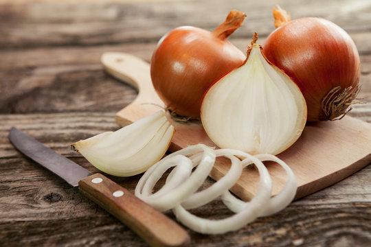 Cut fresh bulb of onion on cutting board