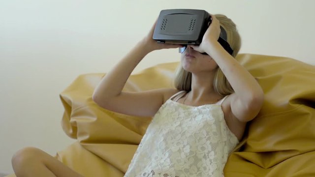 Teenager girl shaking her head in vertual glasses