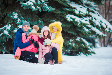 Happy family enjoy winter snowy day