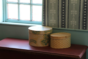 primitive shaker boxes on red wooden table