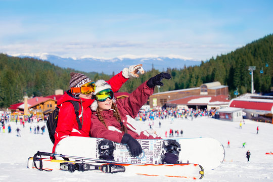 Happy family at the ski resort, winter time, watching mountains