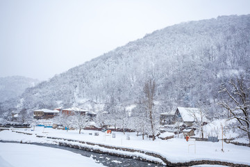 village covered with snow on the pass Rikota, Georgia
