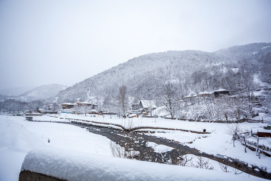 village covered with snow on the pass Rikota, Georgia