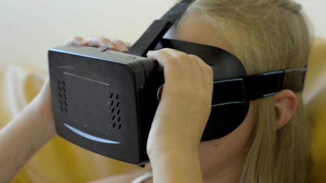 Teenager girl playing in vertual glasses