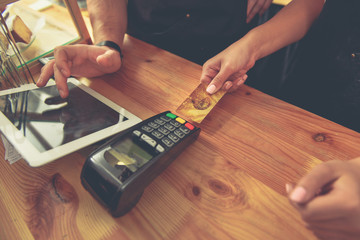 Male and female paying bill in cafe