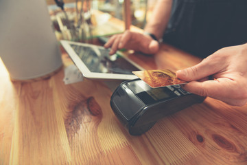 Barista taking credit card to do payment for visitor