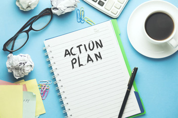 Action plan text written on notebook