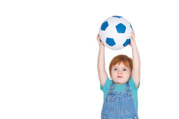 the little boy with red-hair catches a soccerball