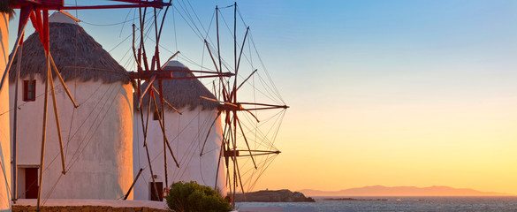 Old windmills on the sunset, Mykonos island, Greece - obrazy, fototapety, plakaty