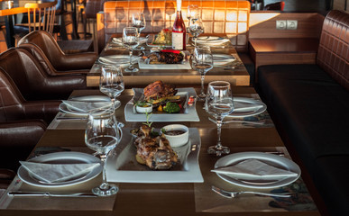 Restaurant table with food and red wine