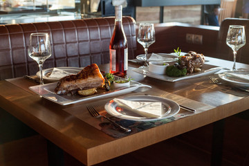 Restaurant table with food and red wine