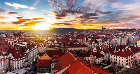 Naklejka premium Most mystical and mysterious city in Europe. Prague through the eyes of birds with magnificent sunset and sky over the traditional houses with red roofs. Old town square, Prague, Czech Republic