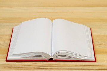 Open book on wooden table.