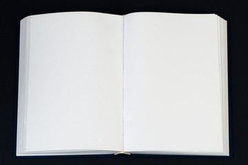 Open book on wooden table.