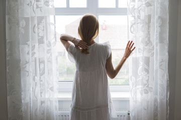 sad lady stay by the window