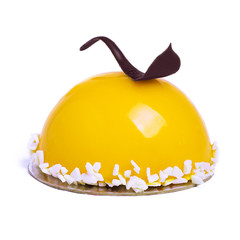 French mousse cake covered with yellow glaze isolated on white. Lemon modern European dessert