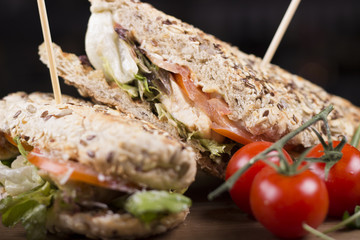 Close up meat sandwiches with lettuce, tomatoes, and french fries on the side. Beautifully served meal at the restaurant.