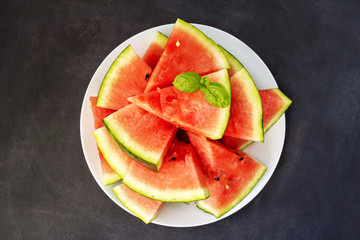 slices of watermelon with basil