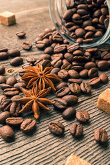 Coffee beans into glass jar table with sugar and anise
