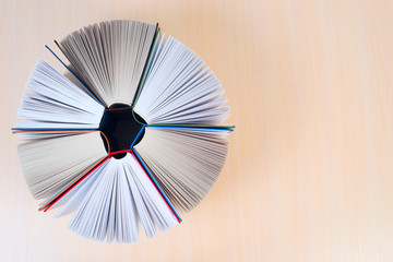 Open books on wooden table.