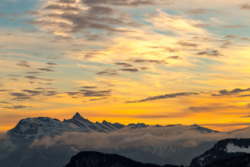 Vibrant orange sunset over snowy mountains