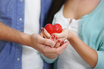 Couple hands with red heart, closeup