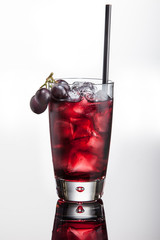 Vodka cocktail with grape juice, ice grapes. On white background with reflection.