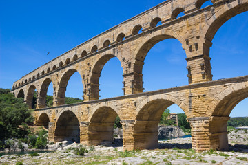 Fototapeta na wymiar Famous In ancient aqueduct Pont du Gard is an old Roman aqueduct in Southern France.
