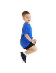 Little sportive boy posing on white background