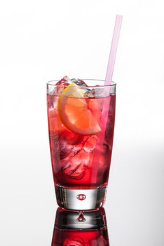 Vodka Cocktail With Cranberry Juice, Soda Water, Lemon And Ice. On White Background With Reflection.