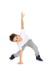 Cute boy dancing on white background