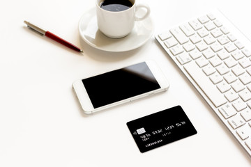credit card, keyboard, smartphone and coffee cup on white background