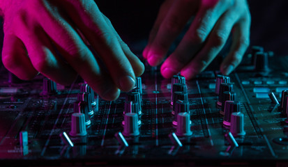 DJ sound equipment at nightclubs and music festivals, EDM, future house music and so on. Parties concept, sound technique. DJ playing on the best, famous CD players.