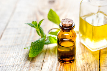 organic cosmetics with herbal extracts of mint on wooden background