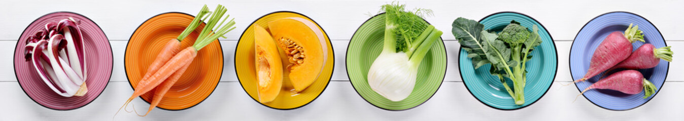 Collection de légumes colorés sur fond en bois blanc, vue de dessus, mise à plat.