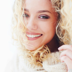portrait of beautiful happy woman with curly hair and adorable smile