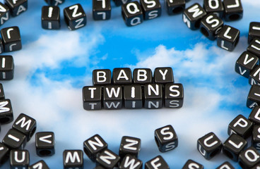 The word baby twins on the sky background