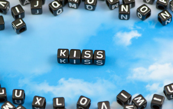 The word kiss on the sky background