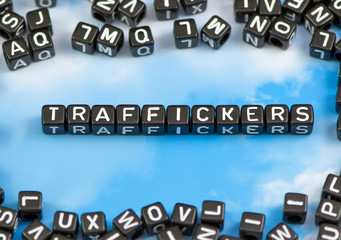The word Traffickers on the sky background