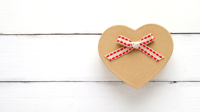 Vintage heart shape gift box on white wood background