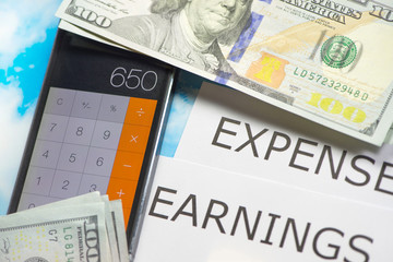 Fototapeta premium Expenses and earnings in the form of a calculator concept