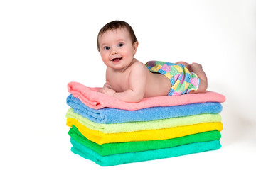 Newborn baby lying on a stack of towels