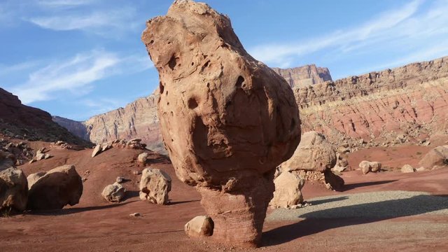Timelapse of people walking around large stones, at a red desert , that looks like the planet mars, near marble canyon, in Arizona, United states of America