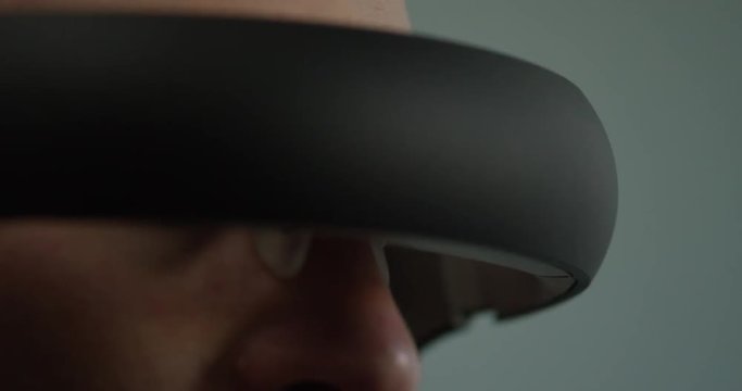 Extreme closeup of futuristic headset on young man's head