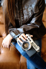 Girl holding vintage camera in her hands