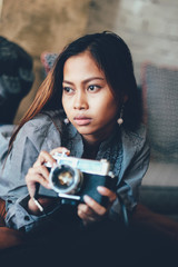 Gorgeous girl lying with photo camera in her hands