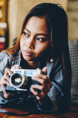 Gorgeous girl lying with photo camera in her hands
