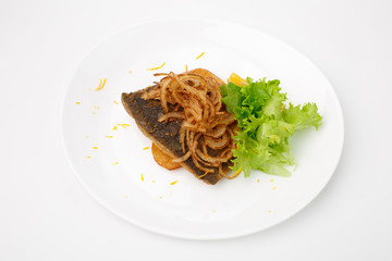 grilled fish with vegetables on a white background